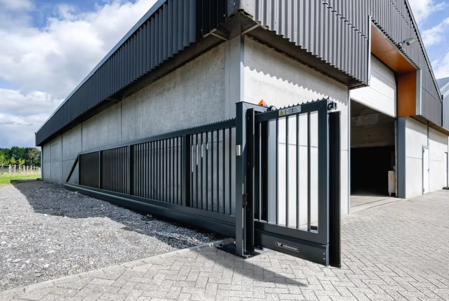 Automatic gate repair being carried out by a Charged Services engineer in Essex
