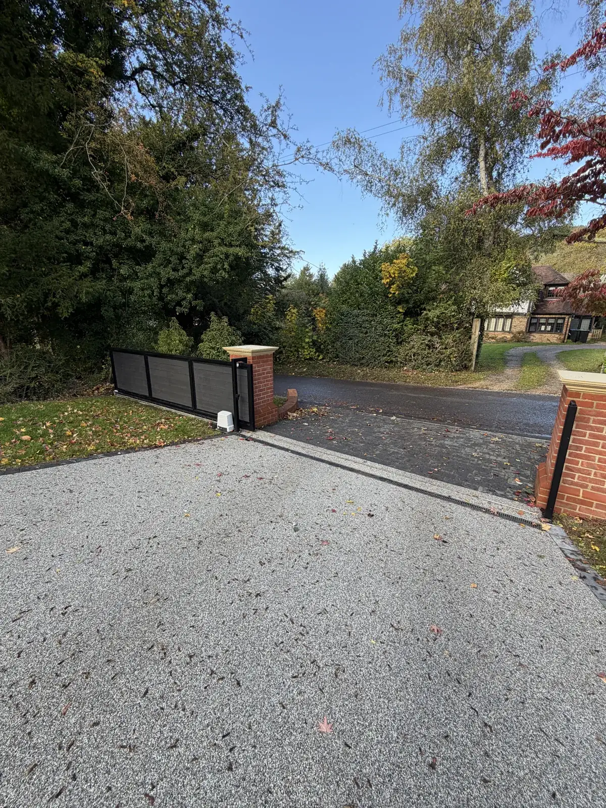 Automated sliding gate on a resin driveway